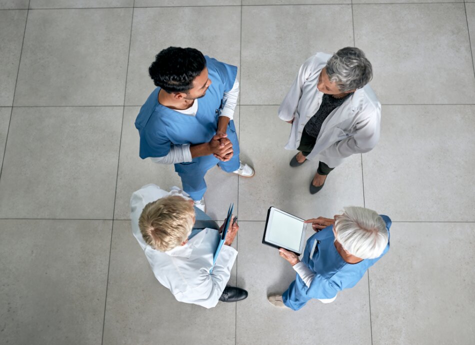 Aerial view of 4 healthcare professionals talking 
