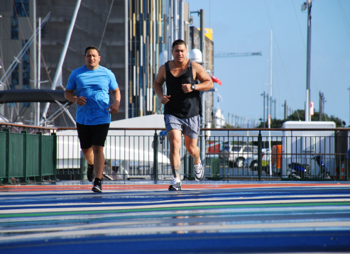 Two men jogging by waterfront in Auckland city