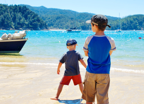 two boys at the beach in Abel Tasman New Zealand Canva