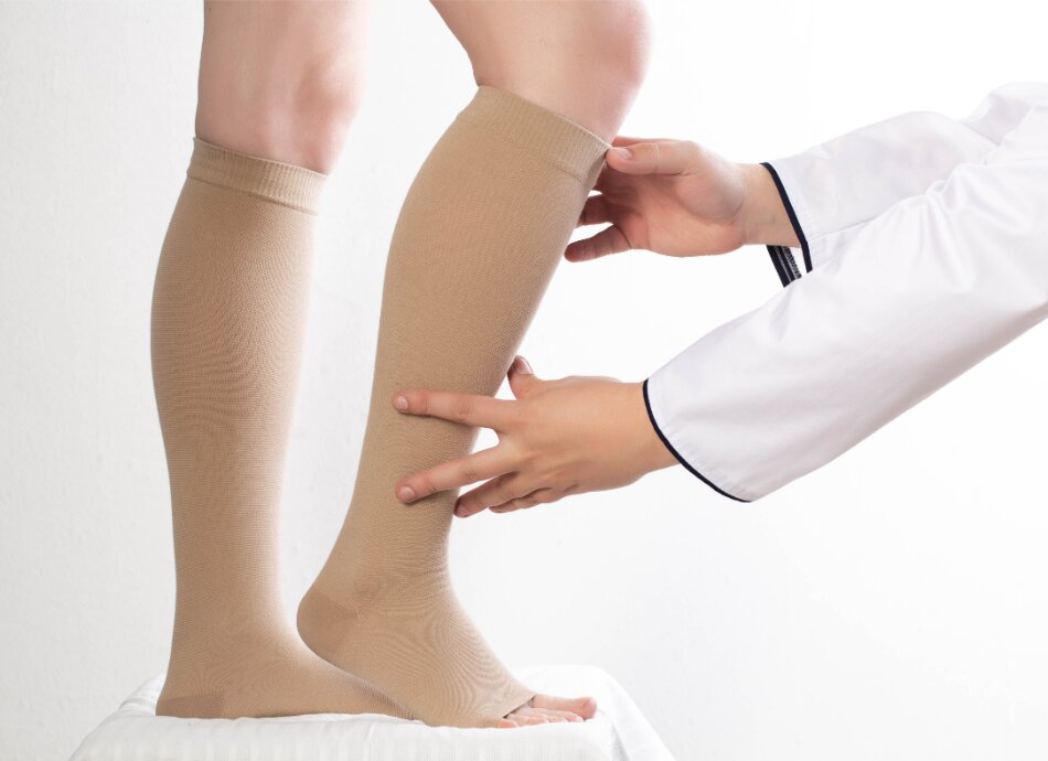 Compression stockings being fitted on legs