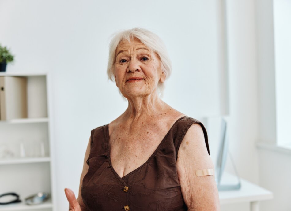 Older woman with bandaid on left upper arm