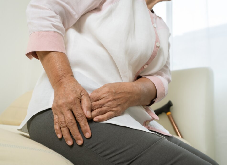 Woman holding painful hip
