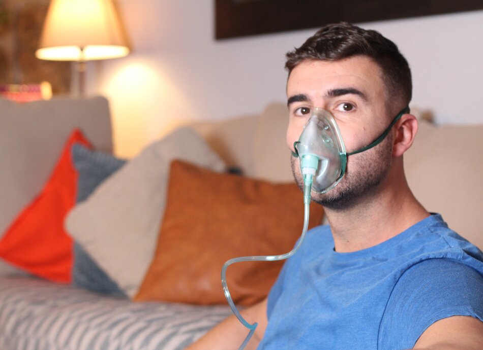 Man wearing oxygen mask at home
