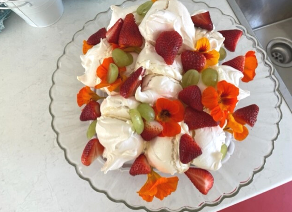 Meringue dessert with strawberries and flowers