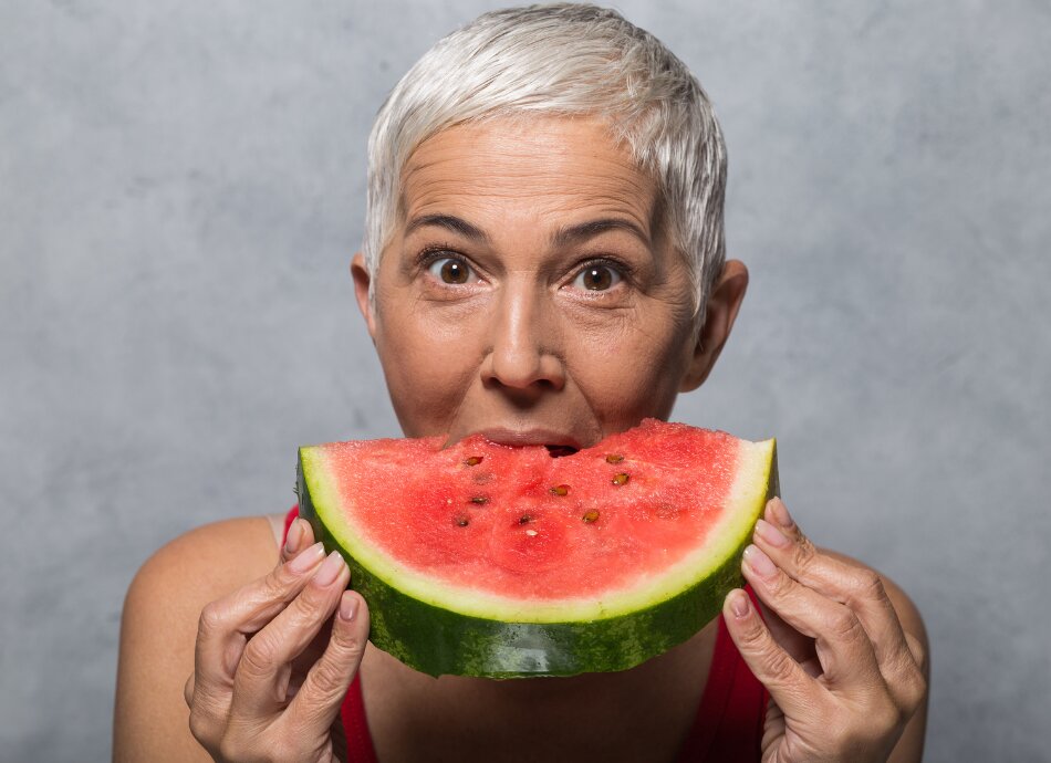 Older woman eating watermelon canva 950x690