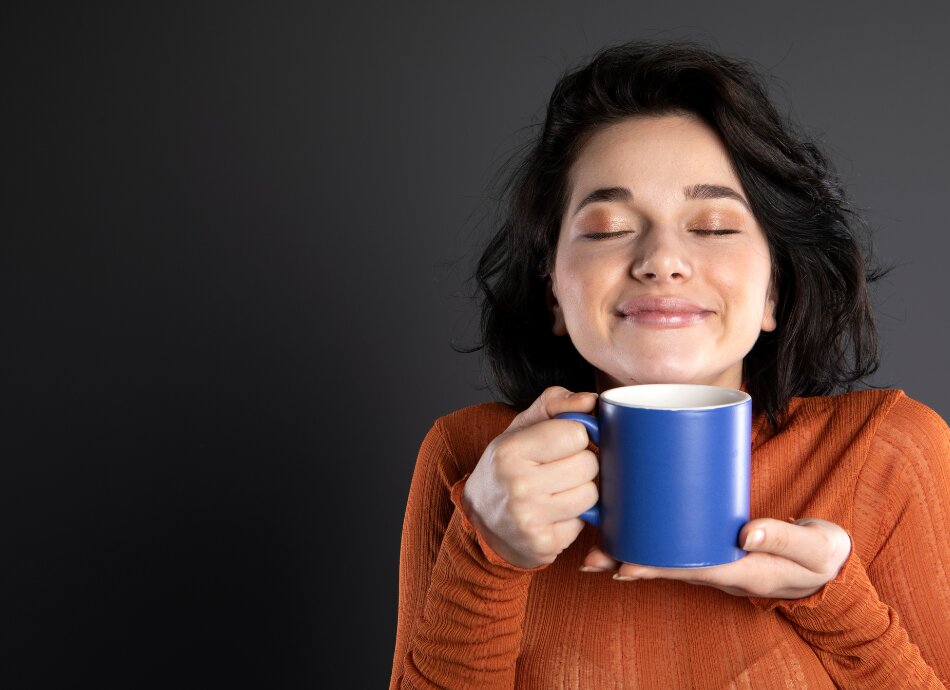 Woman enjoying mug of coffee 
