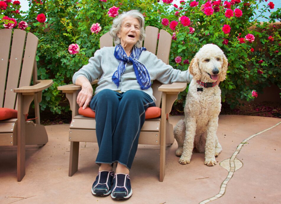 Older woman in garden with dog