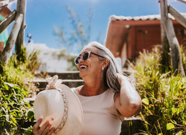 Woman enjoying the sunshine with sunglasses and hat