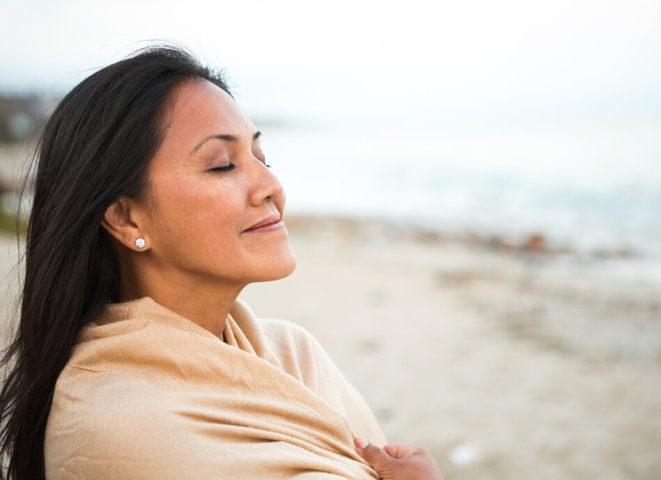 Peaceful strong woman meditates with eyes closed