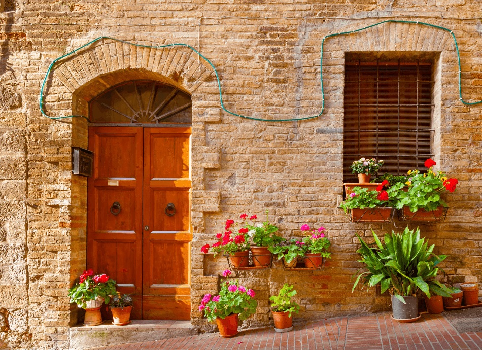 House with potted geraniums Tuscany 