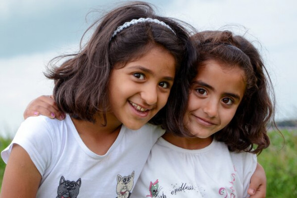 2 refugee girls smiling