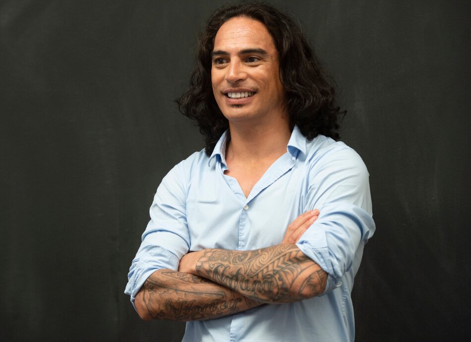 Pasifika man with sleeves rolled up showing tattoos